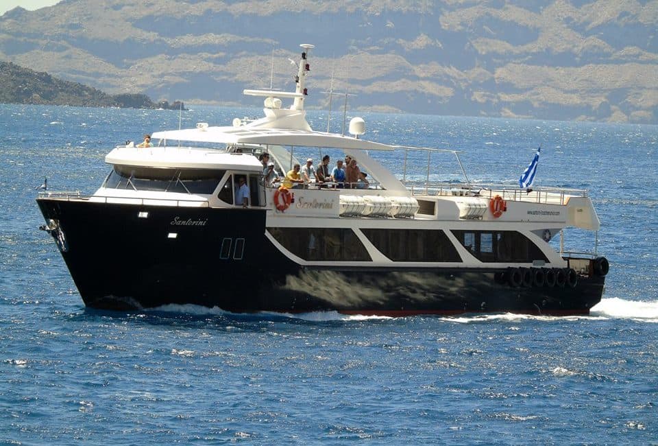 Embarcation de Maistros Santorini avec des gens à bord sous un beau soleil.
