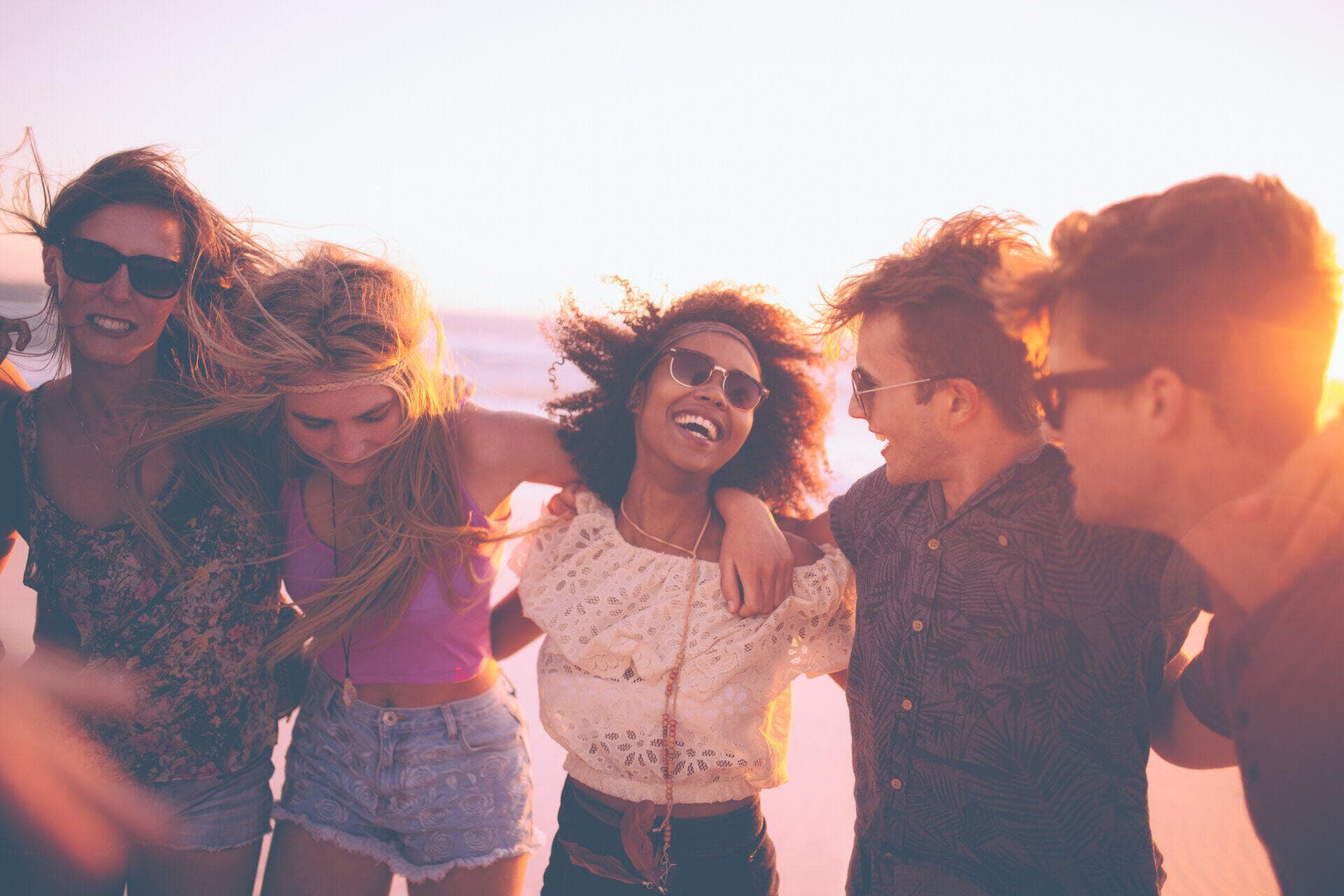Un groupe d'amis dans la trentaine profitant d'un moment d'allégresse sur une plage grecque