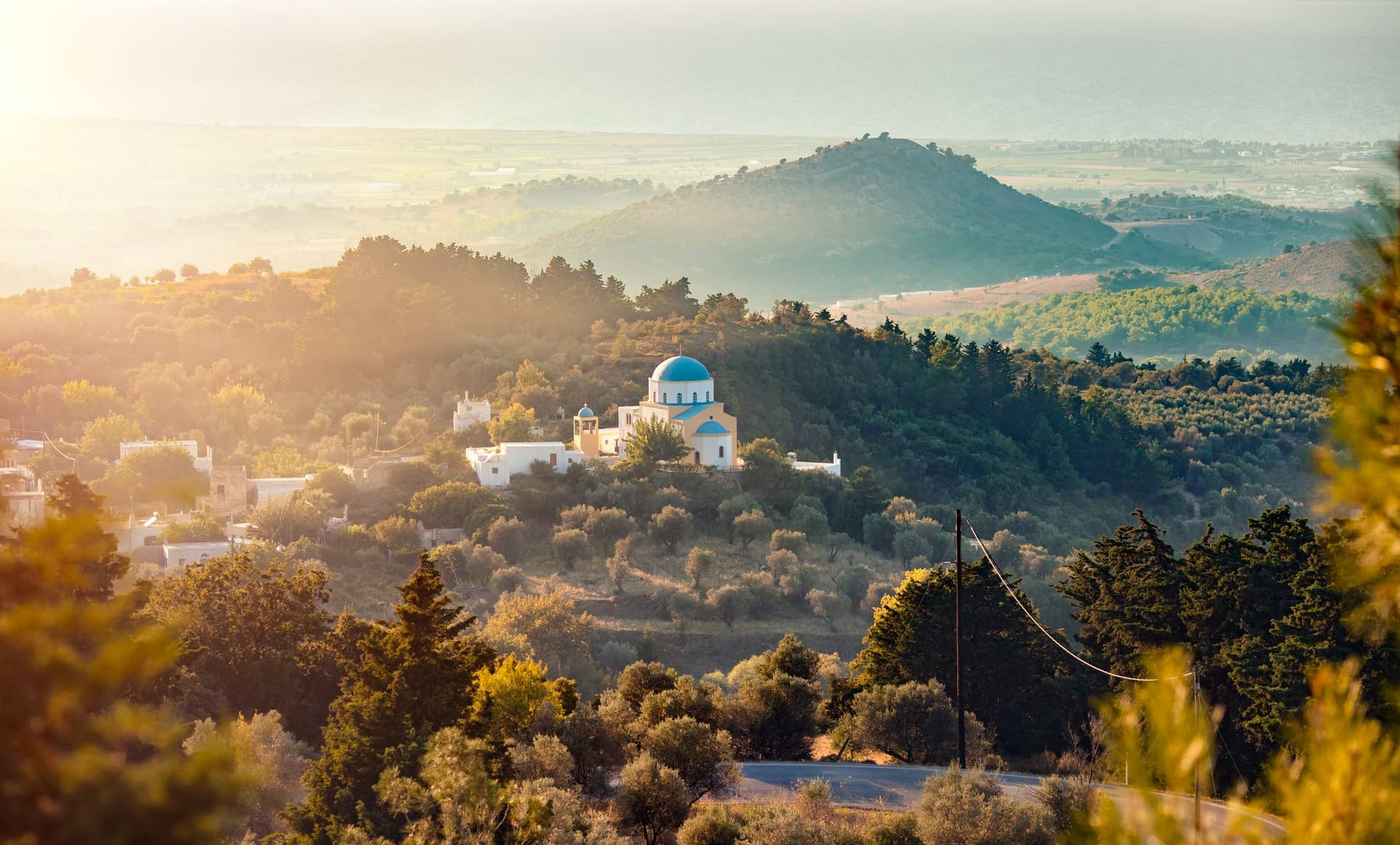 Sun rises on the lush green hills of Kos, Greece.