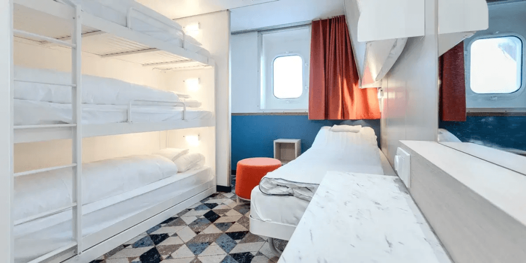 A ferry cabin on a DFDS ship with three bunk beds, 1 seperate bed and a window to offer a sea view.