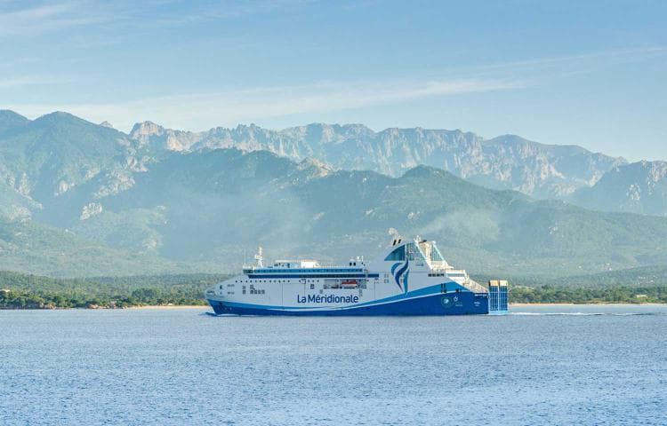 A ferry from La Méridionale gliding across calm, clear waters 