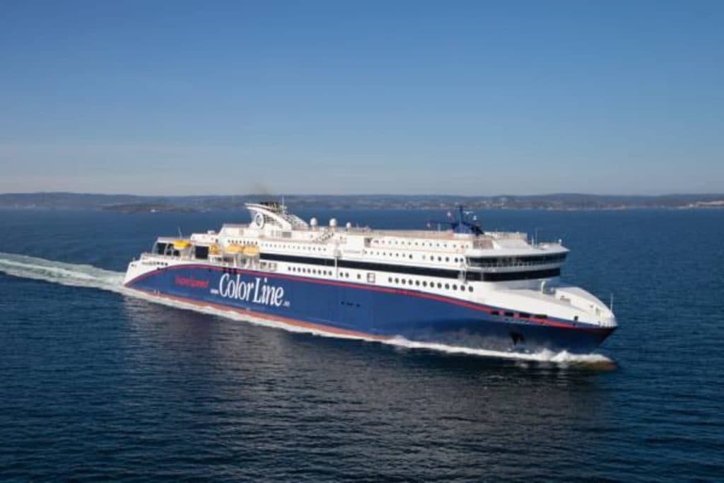 A large Color Line ferry sailing through calm blue waters under a clear sky