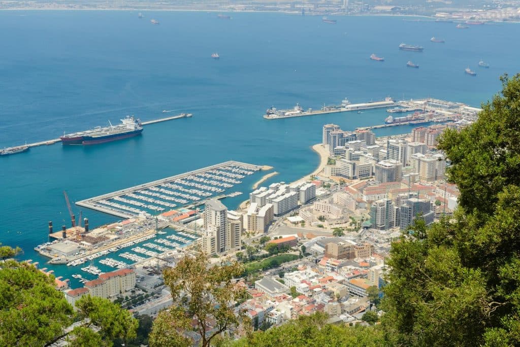 THe port of Gibraltar as seen from above, with a ship parked inside.