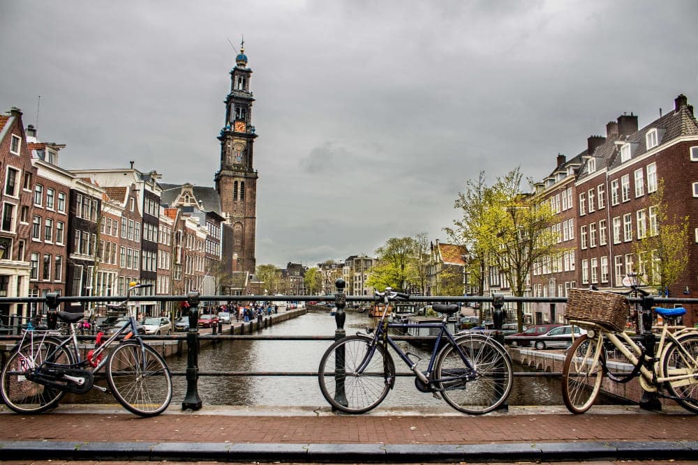 A classic scene of Amsterdam, Netherlands, featuring a picturesque canal lined with traditional Dutch buildings