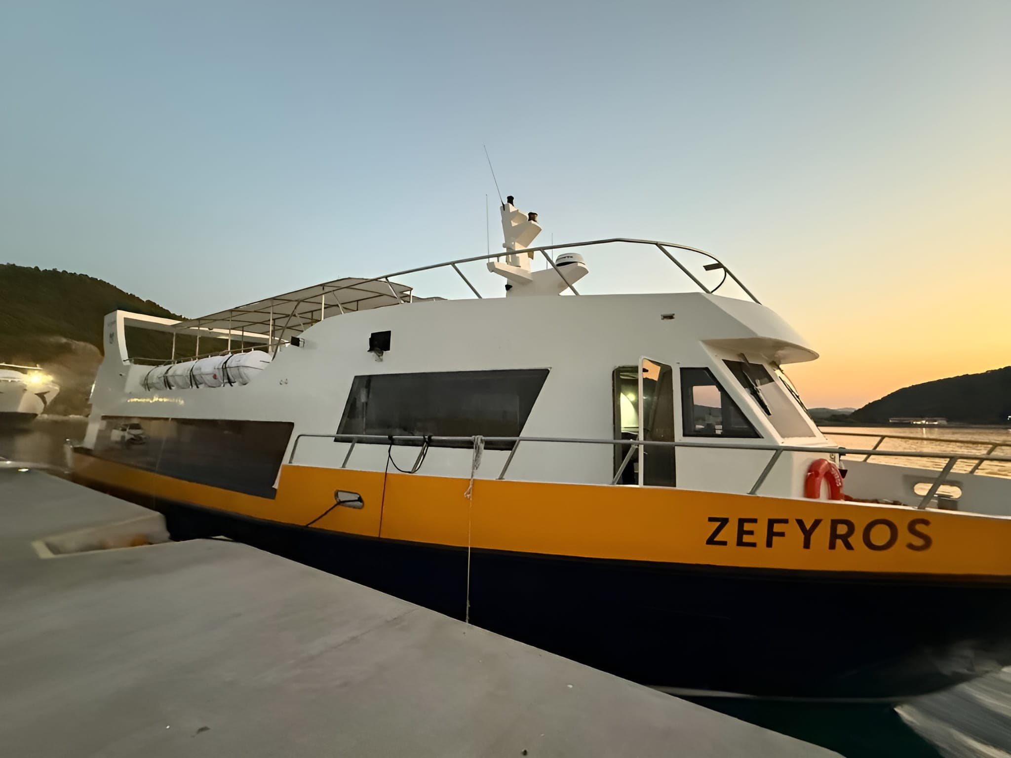 Mantoudi Line's Zefyros vessel rests at a port during sundown.