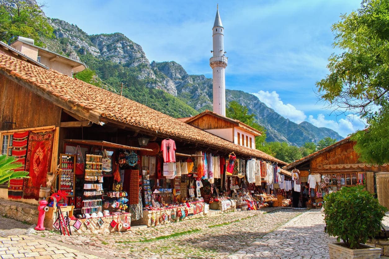 Colorful old Bazaar and a synagogue with a mountain in a background in Kruja, Albania.