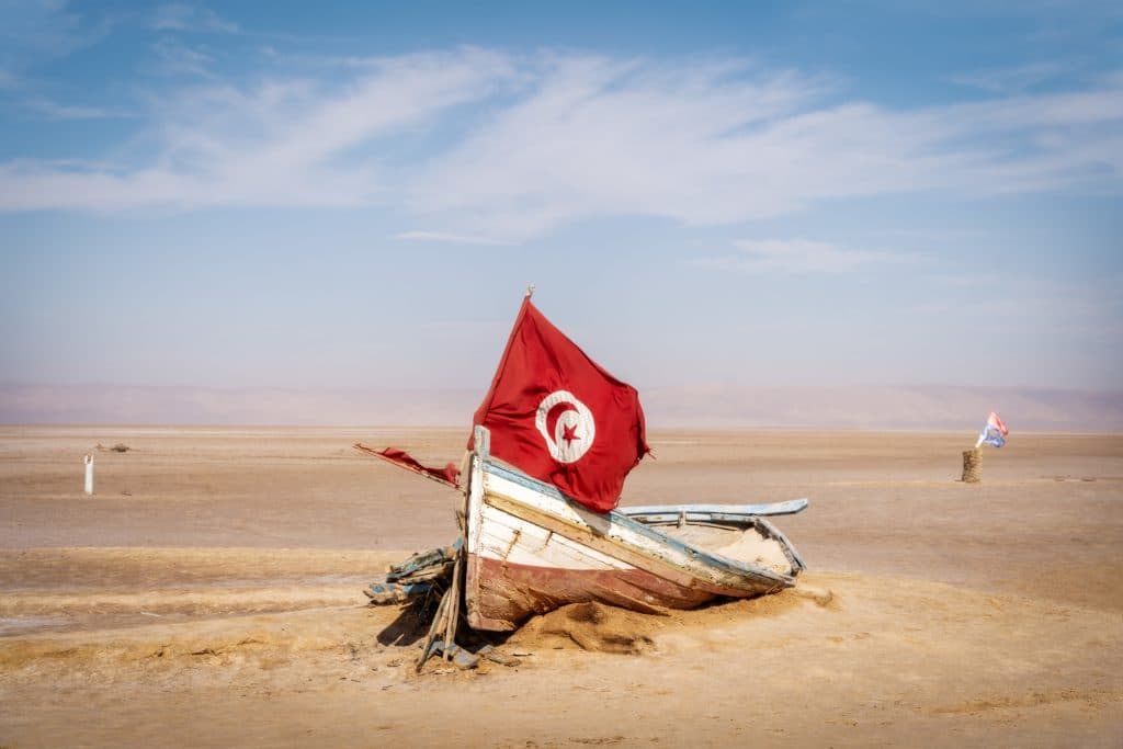 An abandoned boat with a Tunisian flag on it
