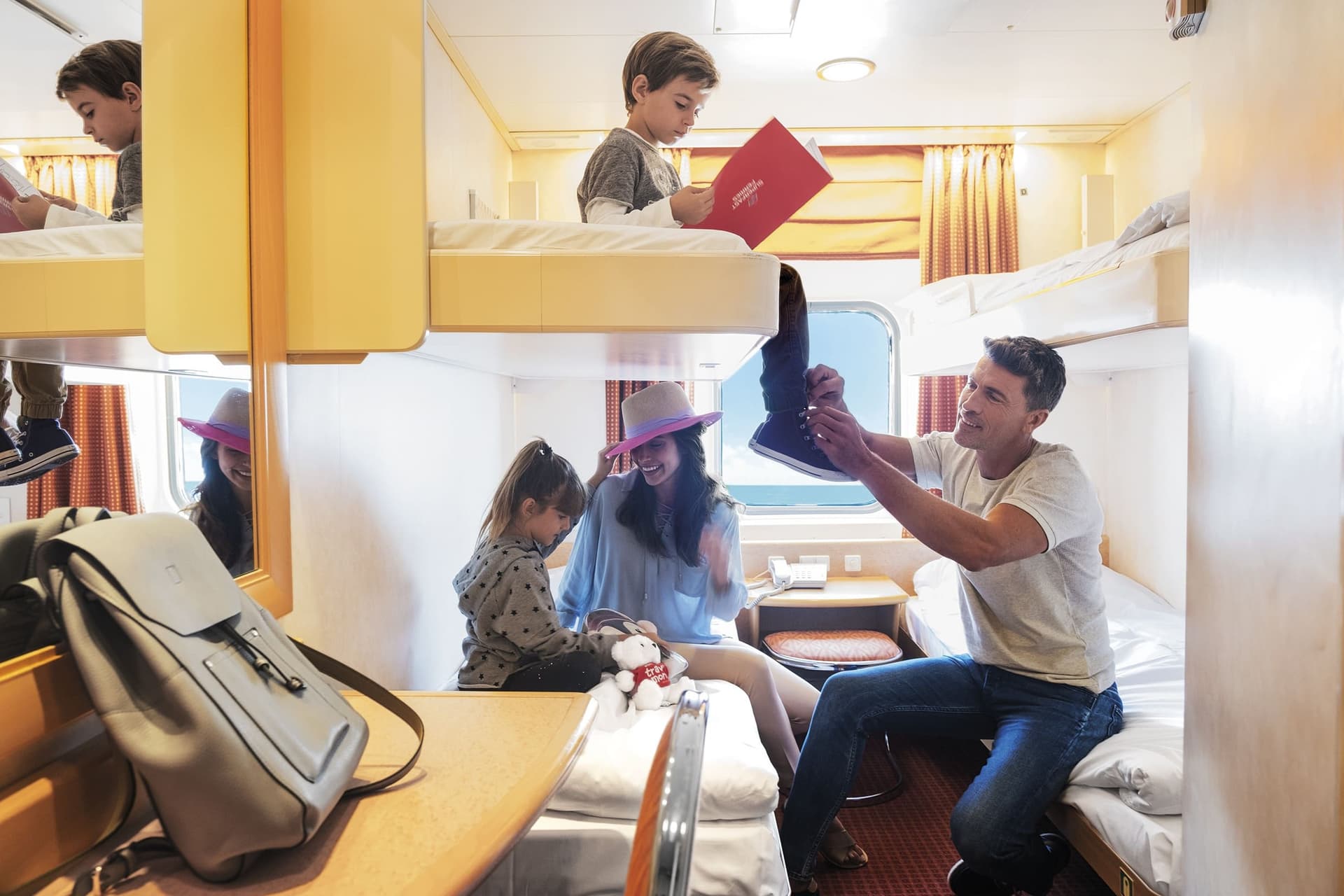 Mom, dad, young son and daughter in a ferry cabin in a Superfast Ferries vessel.