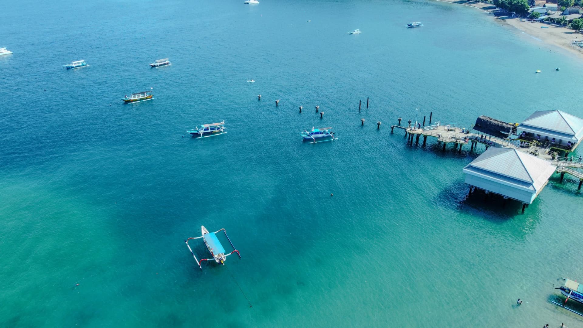 Aerial view of Senggigi beach in sunny day, ships docked on the coast of Senggigi, floating ships on the beach, Lombok Island, Indonesia stock photo