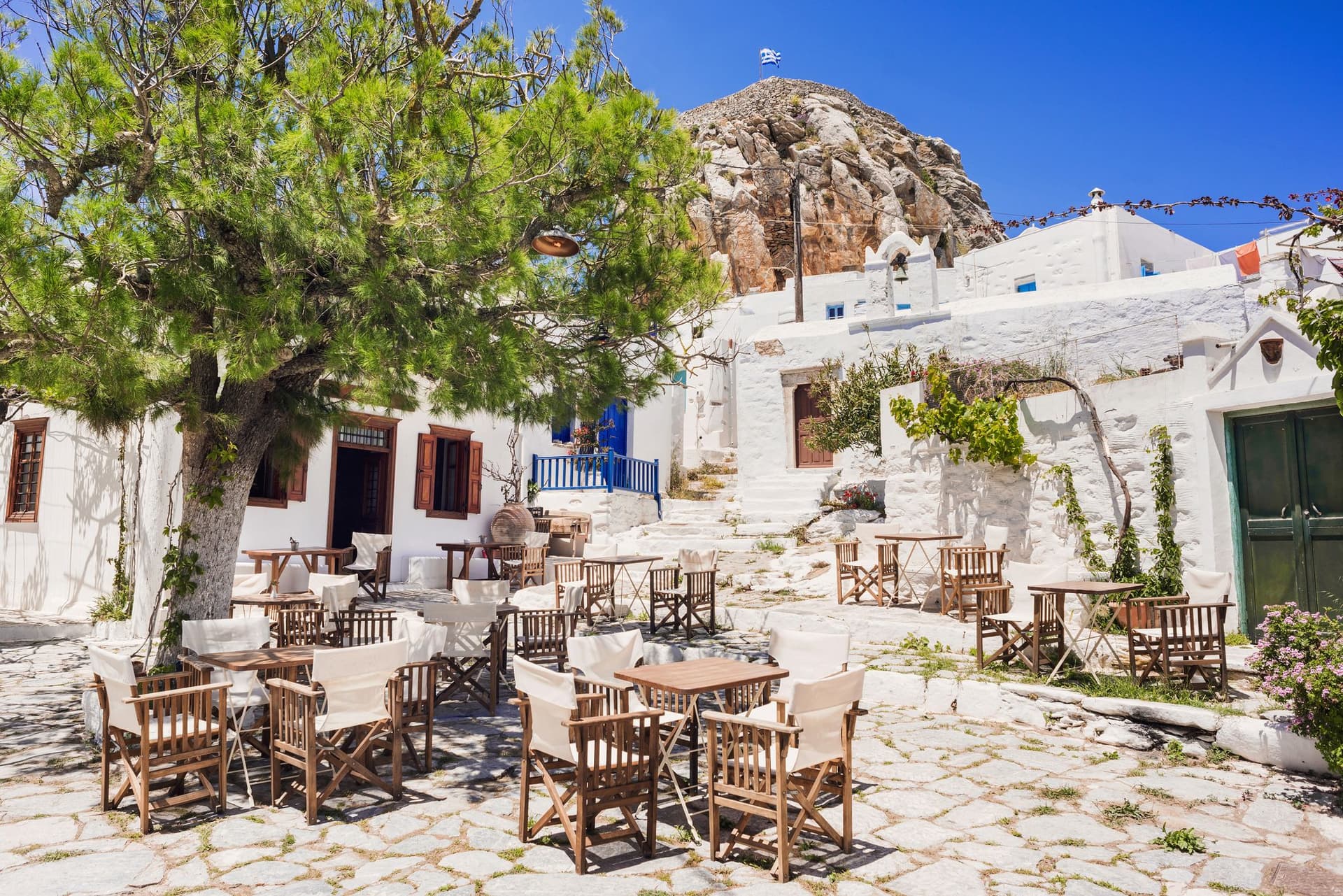 A taverna on white cobblestone streets in Amorgos, Greece.