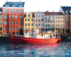copenhagen buildings with red boat in front
