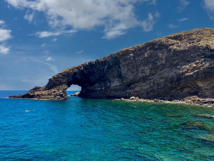 Arco dell’Elefante a Pantelleria, formazione rocciosa vulcanica a forma di arco sul mare turchese.