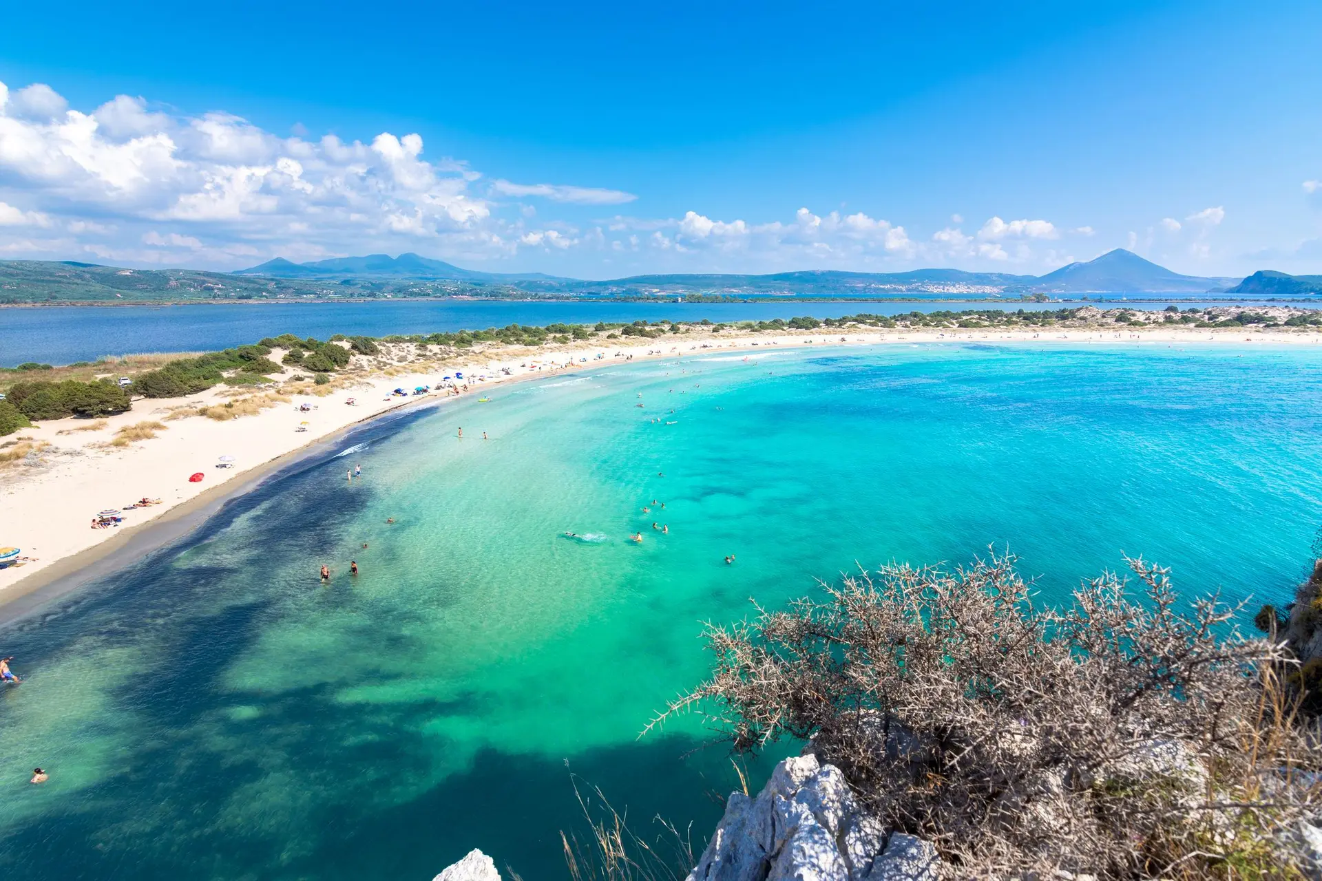 Aerial shot of Voidokilia Beach's turquoise waters.