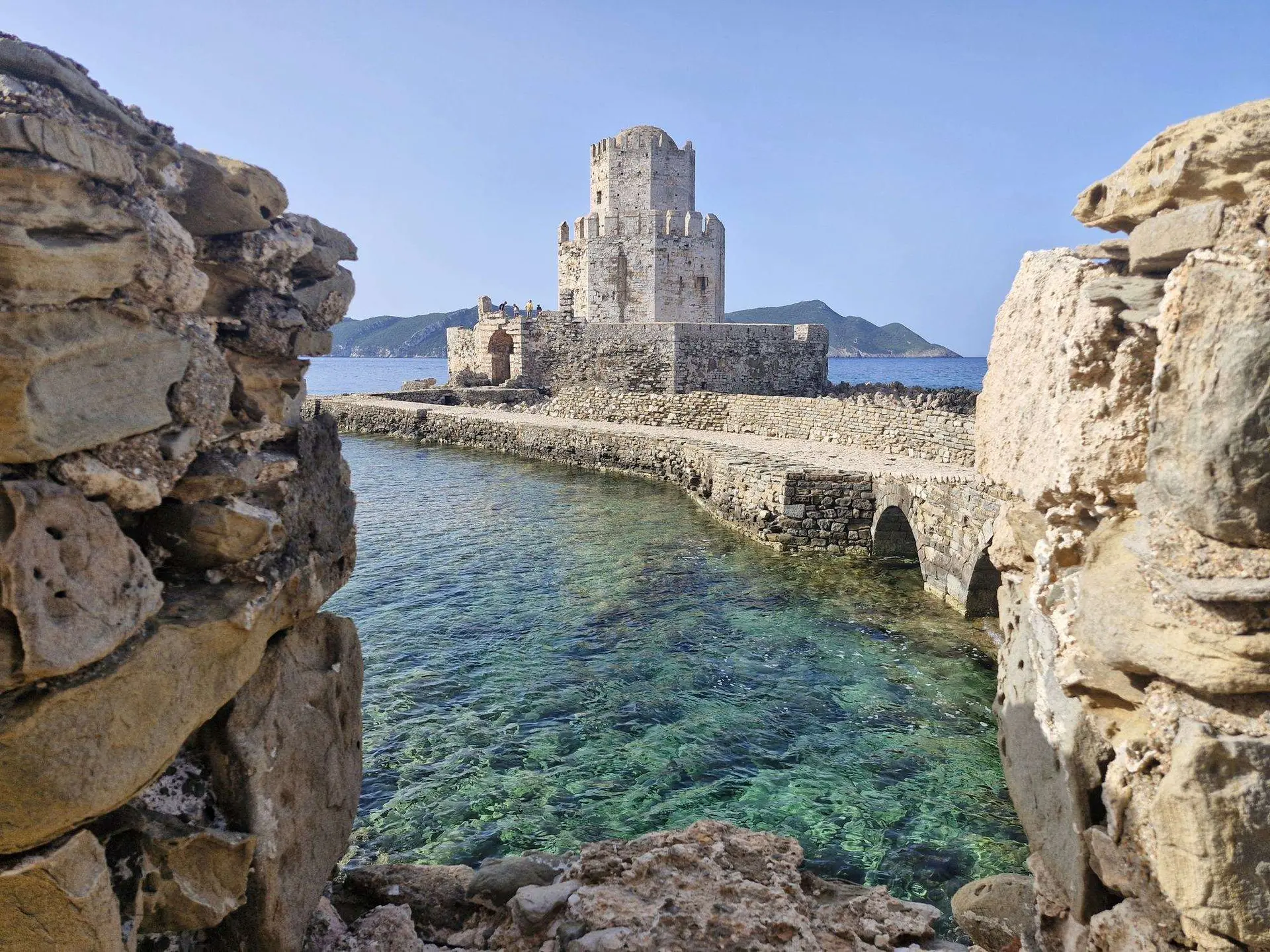 The moat and stone bridge leading towards Methoni Castle in Messinia.
