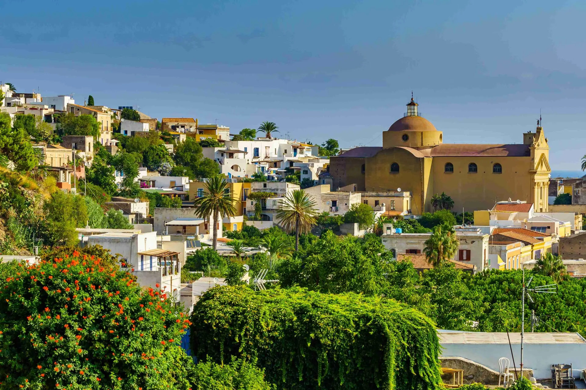 A lush green scene of Santa Marina church in Salina, Sicily.