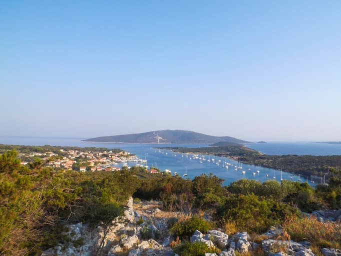 Vista dall'alto sul villaggio e sul porto di Ilovik, Croazia, con barche ancorate nella baia